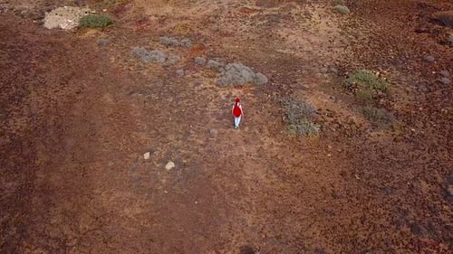 Aerial View of a Woman Hiking Along a Volcanic Surface Tenerife Canary Islands Spain