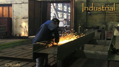 Worker Smooths Metal Beam with Hand Grinder