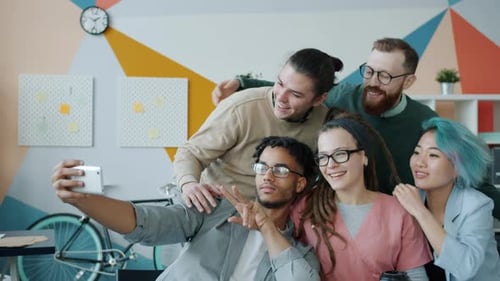 Joyful Colleagues Multi-ethnic Group Taking Selfie with Smartphone Camera in Office