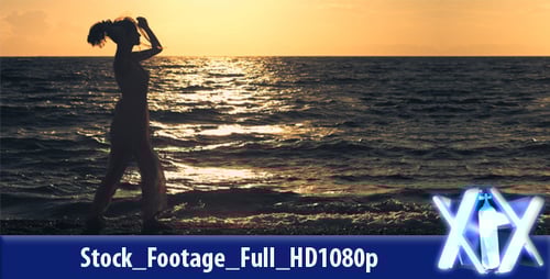 Woman Walking Along Beach