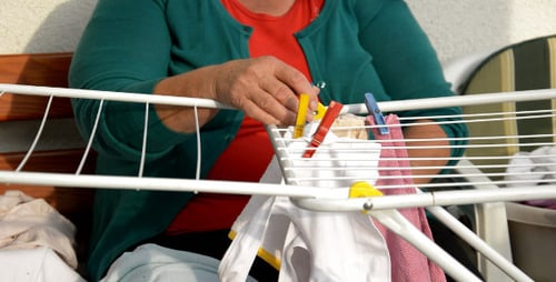 Adult Hanging Clothes on a Drying Rack