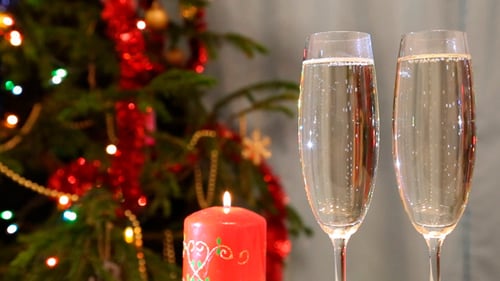 Festive Champagne Toast by Christmas Tree