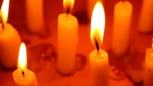 Glowing Candles Burning Brightly in the Darkness