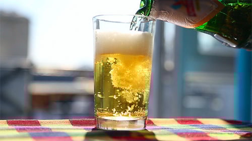 Golden Beer Being Poured into Glass Close Up