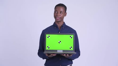 Young Adult Holding Laptop with Green Screen