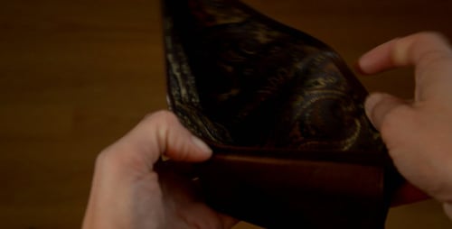 Opening a Brown Leather Wallet Close Up