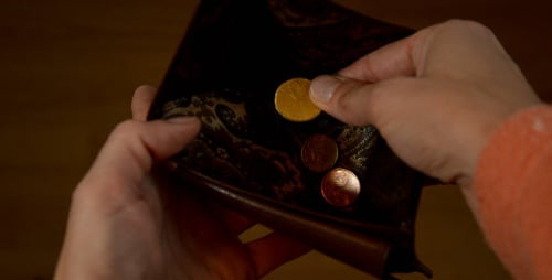 Hands Opening Brown Leather Wallet and Adding Coins