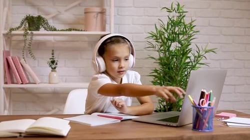 Young Girl Studying at Desk with Laptop