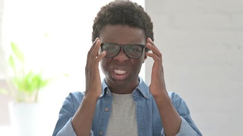 Young Adult with Headache Rubbing Temples