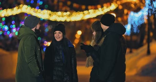 Friends Talk on the Street in Winter