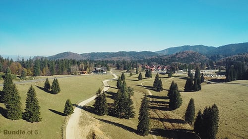 Aerial View of Rolling Hills and Forest Landscape