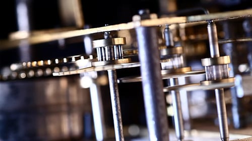 Close Up of Intricate Clock Gears Turning in Slow Motion