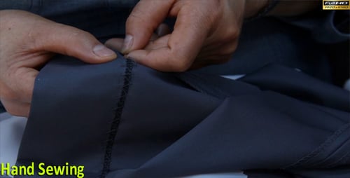 Adult Hands Sewing Fabric with Needle and Thread