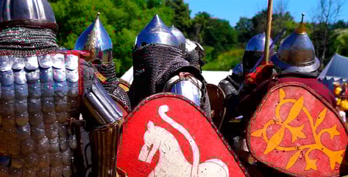 Figures in Metal Armor Standing on Grassy Field