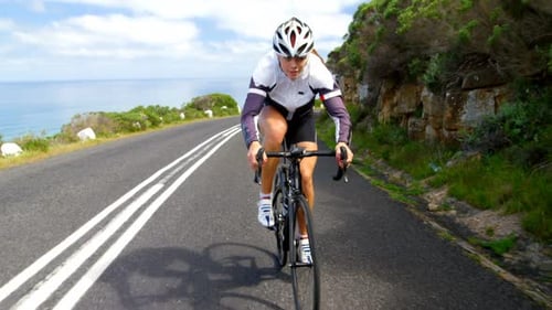 Female cyclist cycling on a countryside road
