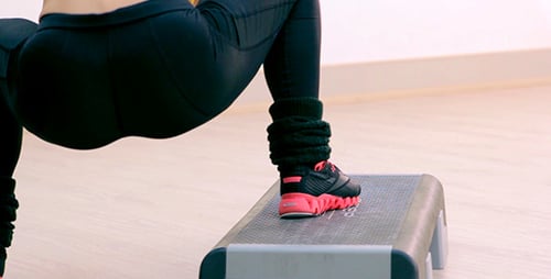 Woman Exercising on Step Aerobics Platforms