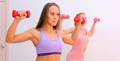 Two Women Performing Arm Exercises with Weights