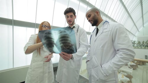 Medical Team Discussing Chest X-Ray in Hospital
