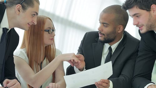 Businessmen Sitting At Table In Office