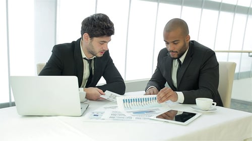 Two Businessman Discussing Documents