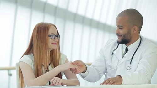 Doctor and Patient Examining X-ray in Office