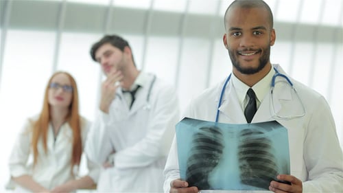 Doctor Examines X-Ray in Bright Hospital Setting