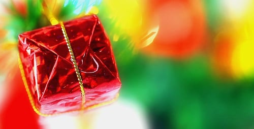 Red Gift Ornament Hanging on Christmas Tree