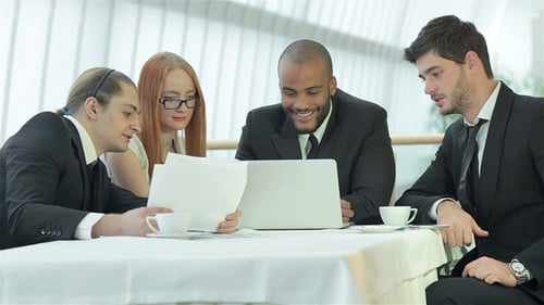Business Team Meets at Restaurant Table, Smiles