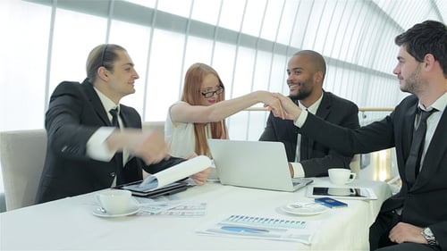 Business People Collaborate at a Table in an Office
