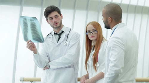 Doctors Discuss X-Ray in Bright Hospital Setting