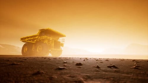 Massive Mining Haul Truck in Dusty Quarry at Sunset