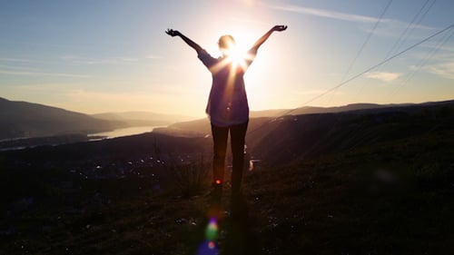 Person Silhouette Arms Raised at Sunrise