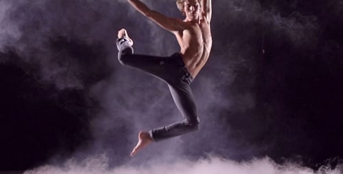 Male Dancer Performing Routine with Clouds in Studio