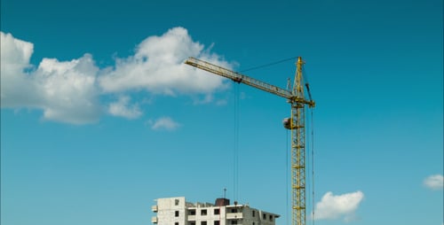 Construction Crane Lifting Materials on Building Site