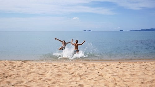 Happy Couple Running to the Sea