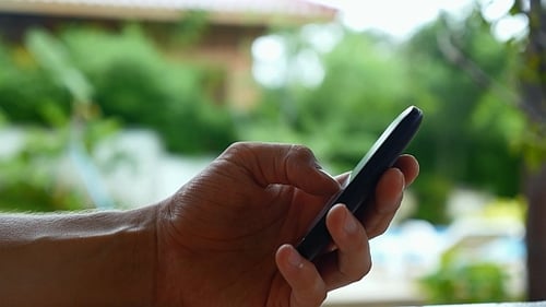 Hand Texting on a Smart Phone Close Up