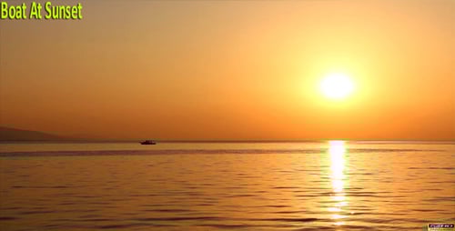 Golden Sunrise Over the Ocean with Distant Boat