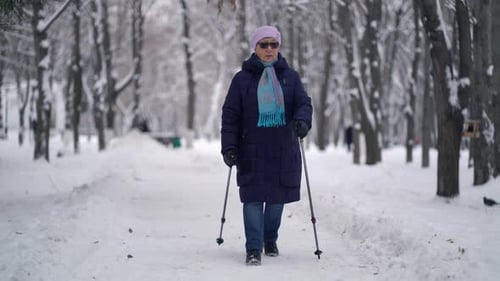 Senior Woman Nordic Walking in Winter Park