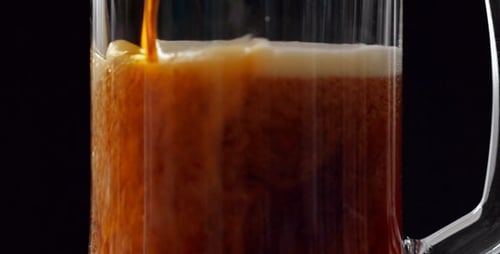 Amber Liquid Poured into Clear Glass Mug