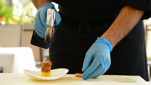 Chef Preparing Food With Culinary Blow Torch