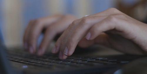 Hands Typing on a Computer Keyboard in Office