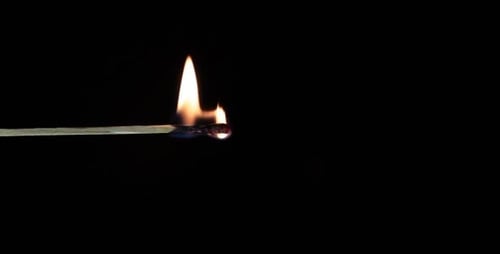 Burning Matchstick Flame on Black Background