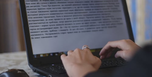 Hands Typing on Laptop Computer Keyboard