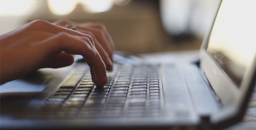 Typing on Laptop in Office