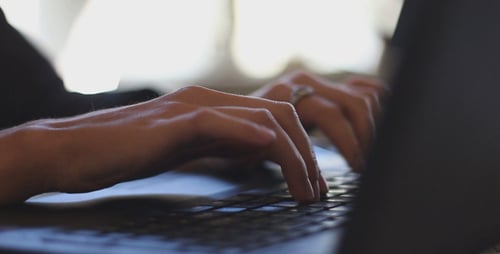 Woman Typing on a Laptop Keyboard Close Up