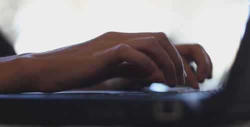 Business Woman Typing on Laptop in The Office