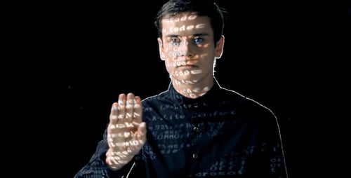Man with Code Projection on Face and Clothing