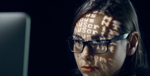 Woman Works with Computer Coding on Face