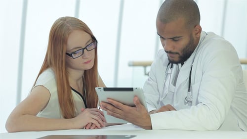 Medical Team Reviews X-Ray and Tablet Data