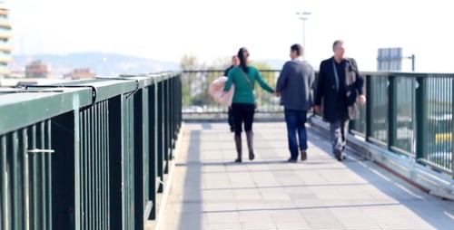 People Walking on Bridge in Urban Environment